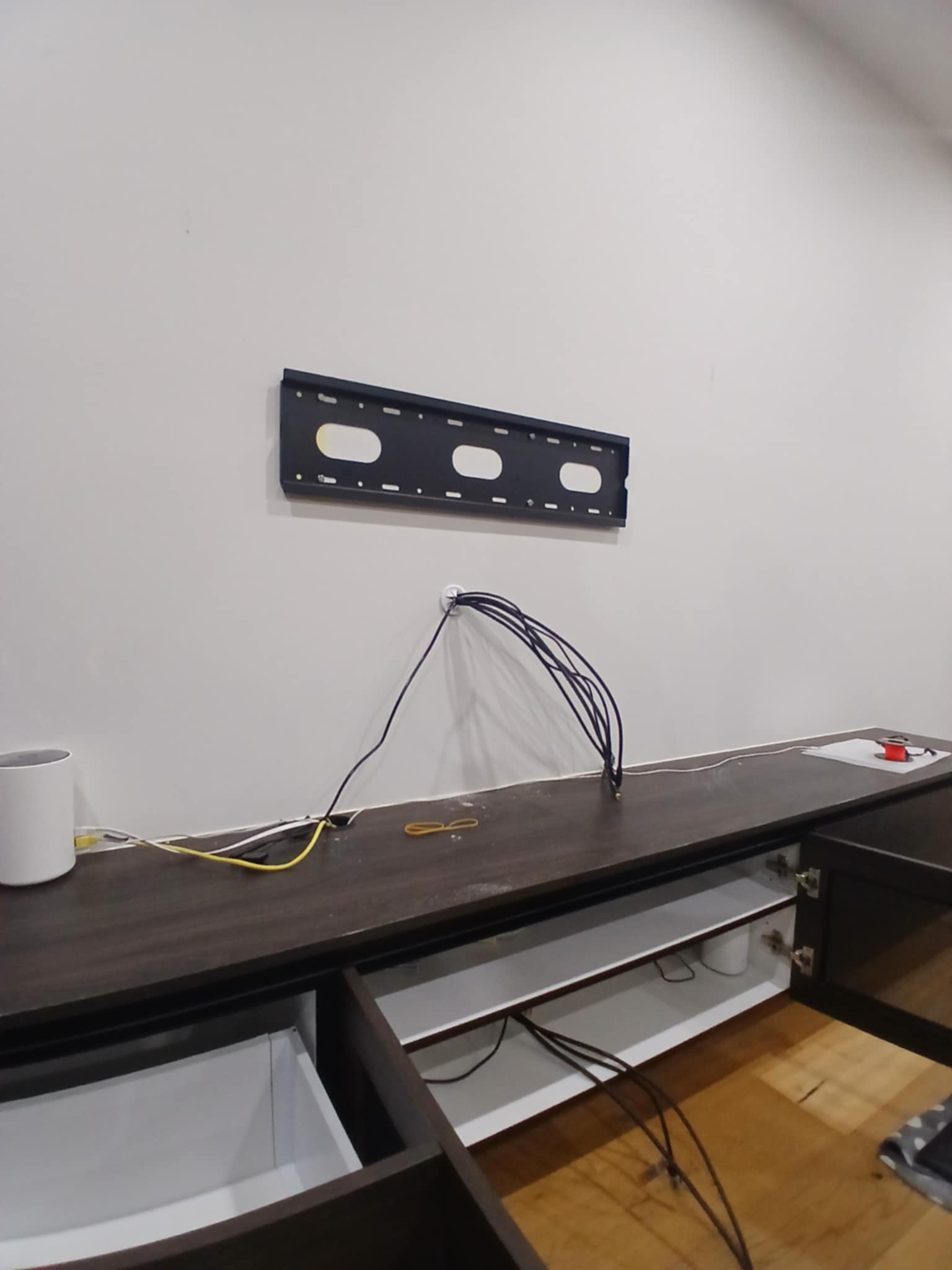 Installer checking TV height and placement with a customer before drilling