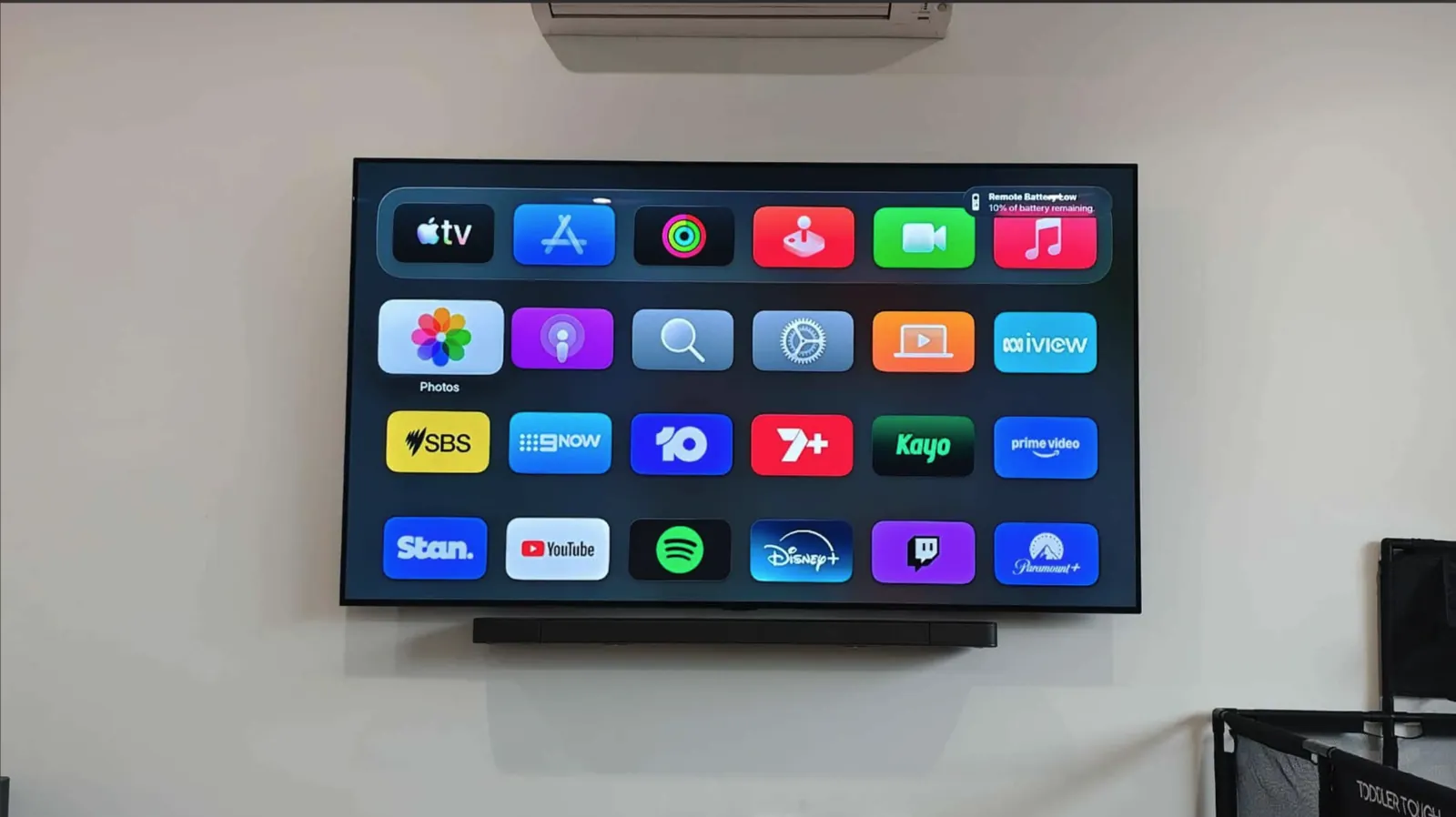 TV with Apple TV home screen mounted above a soundbar
