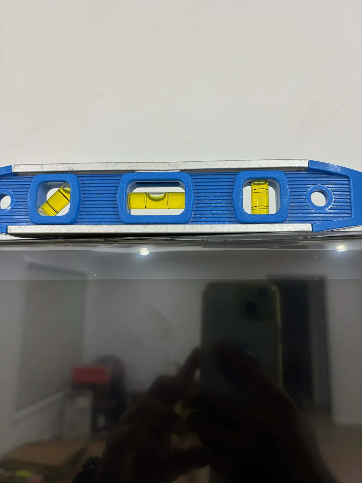 Checking the wall mounted TV is perfectly level