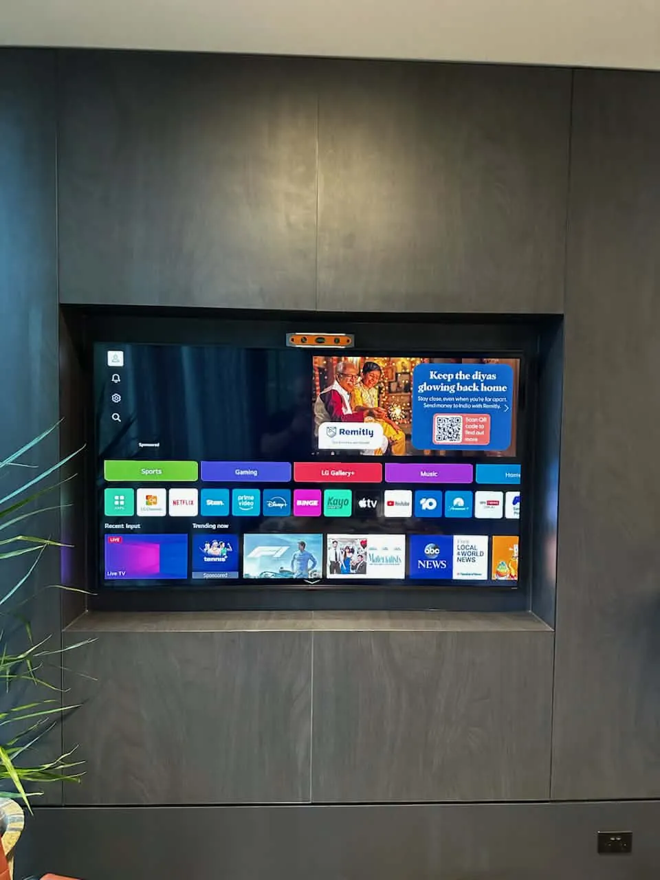 TV recessed into dark cabinetry wall